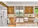 Well-lit kitchen features stainless steel appliances, tiled backsplash, and granite countertops at 10987 Santorini Dr, Las Vegas, NV 89141