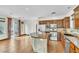 Open concept kitchen with wood cabinets, tile floors, stainless appliances and center island at 10987 Santorini Dr, Las Vegas, NV 89141