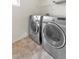 Modern laundry room features stainless steel washer and dryer at 10987 Santorini Dr, Las Vegas, NV 89141