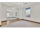 Bright living room featuring hardwood floors, a large window, and seamless access to the adjacent room at 10987 Santorini Dr, Las Vegas, NV 89141