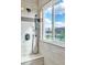 Shower featuring a tile surround, bench seat, shower head, and a window with outside views at 10987 Santorini Dr, Las Vegas, NV 89141