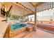 Backyard featuring a hot tub and a covered patio with TV at 1126 Winter Storm Dr, Henderson, NV 89052