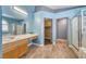 Bright bathroom features tiled floors, wood vanity, and a glass-enclosed shower at 1126 Winter Storm Dr, Henderson, NV 89052