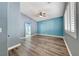 This bedroom features wood flooring, a ceiling fan, and an arched entryway at 1126 Winter Storm Dr, Henderson, NV 89052