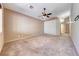 Spacious bedroom features plush carpeting and a ceiling fan with a light fixture at 1126 Winter Storm Dr, Henderson, NV 89052