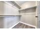 Walk-in closet featuring ample shelving and laminate flooring at 1126 Winter Storm Dr, Henderson, NV 89052