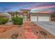 Charming home with desert landscaping, tiled roof and dramatic sunset sky at 1126 Winter Storm Dr, Henderson, NV 89052