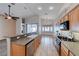 Bright kitchen featuring wooden cabinets, stone countertops, stainless steel appliances, and a breakfast bar at 1126 Winter Storm Dr, Henderson, NV 89052