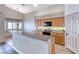 Kitchen with light wood cabinets, a breakfast bar, stainless sink and modern light fixture at 1126 Winter Storm Dr, Henderson, NV 89052
