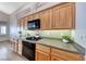 Close up of bright kitchen featuring wood cabinets, gas range, and stone countertops at 1126 Winter Storm Dr, Henderson, NV 89052