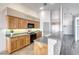 Bright kitchen with wood cabinetry, breakfast bar, modern appliances, and stone countertops at 1126 Winter Storm Dr, Henderson, NV 89052
