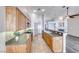 Open concept kitchen features wooden cabinets, modern appliances, tile flooring and breakfast bar at 1126 Winter Storm Dr, Henderson, NV 89052