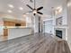 Open-concept living room featuring a fireplace, modern flooring, and direct kitchen access at 1126 Winter Storm Dr, Henderson, NV 89052