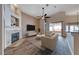 A cozy staged living room, with a fireplace and a sliding glass door to the patio at 1126 Winter Storm Dr, Henderson, NV 89052