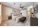 Staged main bedroom showcasing calm colors, a ceiling fan, and an ensuite bathroom at 1126 Winter Storm Dr, Henderson, NV 89052
