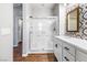 Walk-in shower features tiled walls, a glass door, and marble vanity at 11375 Ogden Mills Dr # 103, Las Vegas, NV 89135