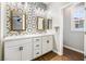 Bathroom boasts dual sinks, marble countertop, and decorative tile accent wall at 11375 Ogden Mills Dr # 103, Las Vegas, NV 89135
