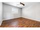 Bright bedroom with wood-look flooring and a ceiling fan at 11375 Ogden Mills Dr # 103, Las Vegas, NV 89135