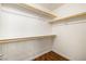 Walk-in closet with wood look floors and white shelving, providing ample storage space at 11375 Ogden Mills Dr # 103, Las Vegas, NV 89135