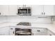 Modern kitchen features stainless steel appliances and white cabinetry at 11375 Ogden Mills Dr # 103, Las Vegas, NV 89135