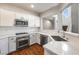 Modern kitchen with stainless steel appliances and quartz countertops and white cabinets at 11375 Ogden Mills Dr # 103, Las Vegas, NV 89135