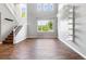 Bright, open-concept living room with hardwood floors, lots of natural light, and high ceilings at 11375 Ogden Mills Dr # 103, Las Vegas, NV 89135