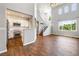 Open floor plan with hardwood floors, connecting to modern kitchen with stainless steel appliances at 11375 Ogden Mills Dr # 103, Las Vegas, NV 89135