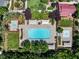 Aerial view of a neighborhood pool with multiple seating areas, water features, and lush green landscaping at 11375 Ogden Mills Dr # 103, Las Vegas, NV 89135
