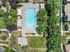 Aerial view of the neighborhood pool featuring crystal blue water surrounded by mature trees and lounge seating at 11375 Ogden Mills Dr # 103, Las Vegas, NV 89135