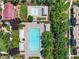 Aerial view of neighborhood pools with lounge seating, mature shade trees, and landscaped areas in an outdoor oasis at 11375 Ogden Mills Dr # 103, Las Vegas, NV 89135