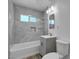 Modern bathroom with gray tile shower, updated vanity, and neutral finishes at 120 Dogwood St, Henderson, NV 89015