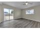 Bright bedroom featuring wood-look floors, sliding glass doors, and a ceiling fan at 120 Dogwood St, Henderson, NV 89015