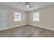 Bright bedroom features updated flooring, fresh paint, and two windows at 120 Dogwood St, Henderson, NV 89015