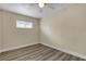 This bright bedroom features hardwood floors, a ceiling fan, and ample natural light at 120 Dogwood St, Henderson, NV 89015