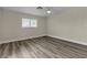 This bedroom offers wood-look floors, a ceiling fan, and a bright window at 120 Dogwood St, Henderson, NV 89015