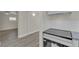 A modern kitchen next to a finished living room area with recessed lights and new flooring at 120 Dogwood St, Henderson, NV 89015