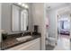 Clean powder room with granite countertop, and a view of another bedroom at 1204 Moselle Ct, Las Vegas, NV 89144