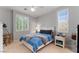 Comfortable bedroom with soft blue bedding, natural light, and a cozy reading nook at 1204 Moselle Ct, Las Vegas, NV 89144