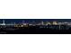 Panoramic night view of the Las Vegas skyline, showcasing the city lights and landmark buildings in the distance at 1204 Moselle Ct, Las Vegas, NV 89144