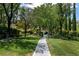 Well-maintained community park walkway surrounded by lush greenery and mature trees at 1204 Moselle Ct, Las Vegas, NV 89144