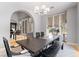 Formal dining room showcases a stylish chandelier and large windows with custom drapery at 1204 Moselle Ct, Las Vegas, NV 89144