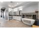 Luxurious main bathroom with a soaking tub, double vanity, tiled floor, and modern fixtures at 1204 Moselle Ct, Las Vegas, NV 89144