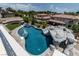 Spectacular backyard features a large pool with a rock slide, hot tub, and lush landscaping at 1204 Moselle Ct, Las Vegas, NV 89144