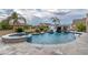 Backyard oasis featuring a custom pool with a rock slide, spa, and lush landscaping at 1204 Moselle Ct, Las Vegas, NV 89144