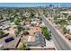 Overhead view of a house with yard and trees, alongside street, surrounded by neighborhood homes and city buildings at 125 S 15Th St, Las Vegas, NV 89101