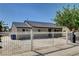 View of home showcasing the backyard and rear exterior, accented by a secure white fence at 125 S 15Th St, Las Vegas, NV 89101