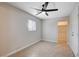 Cozy bedroom with neutral walls, tile flooring, and a modern ceiling fan at 125 S 15Th St, Las Vegas, NV 89101