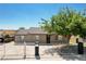Charming single story home with a secure white fence and mature shade tree, offers a welcoming curb appeal at 125 S 15Th St, Las Vegas, NV 89101