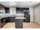 Modern kitchen features granite countertops, dark cabinetry, and a center island, perfect for cooking and entertaining at 125 S 15Th St, Las Vegas, NV 89101