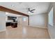 Spacious living room features beamed ceiling and modern ceiling fan, with tile flooring and ample natural light at 125 S 15Th St, Las Vegas, NV 89101